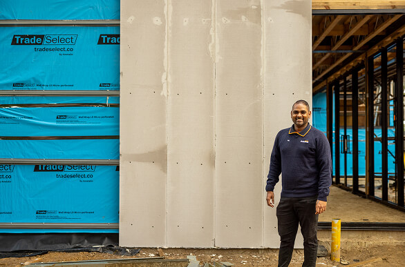 Photo of worker standing in front of cladding