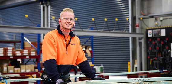 A man in Dahlsens uniform, smiling to camera