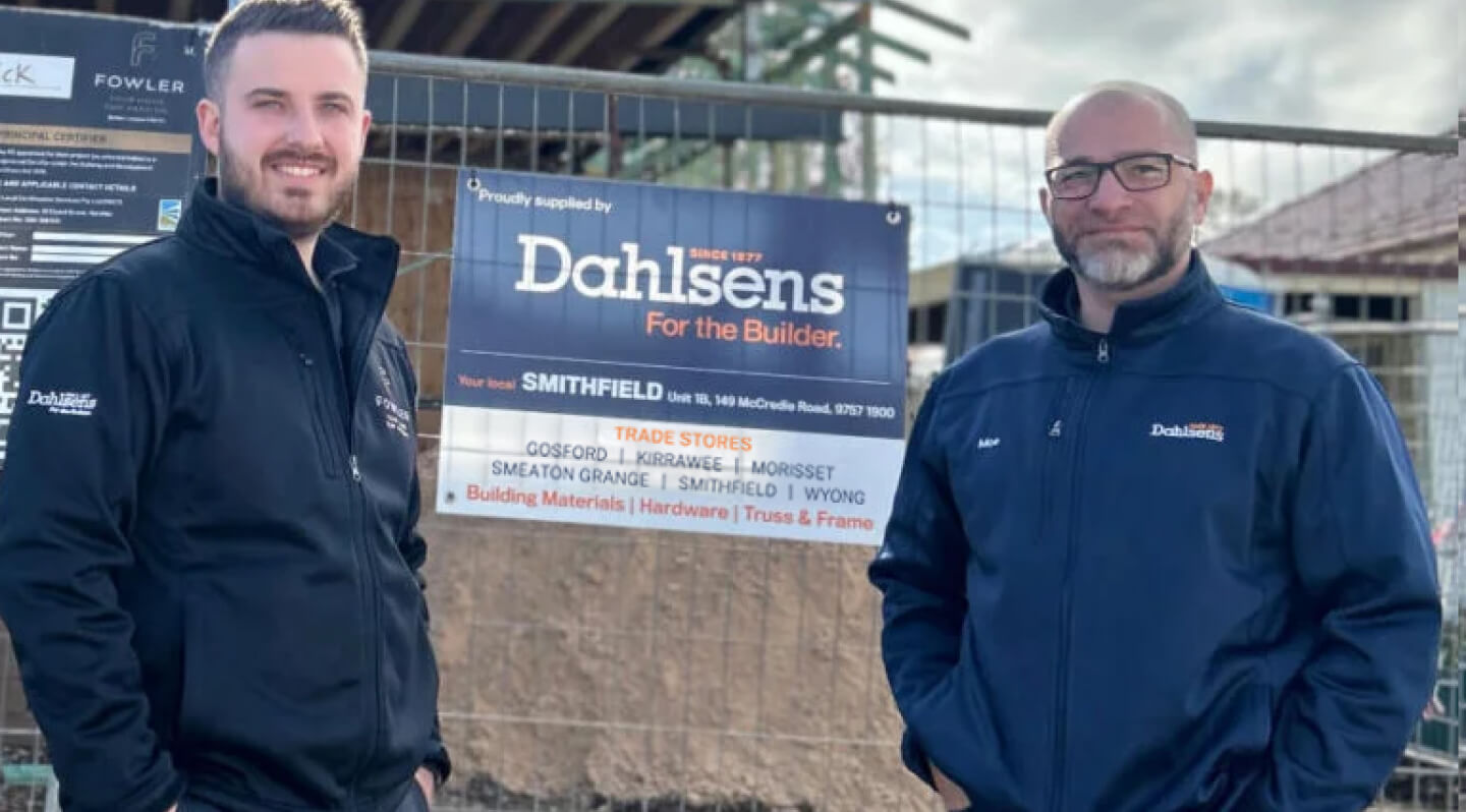 Two Dahlsens team members standing smiling to camera